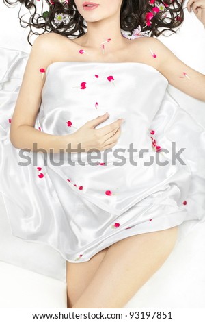 Body of young girl  on the covered with bed sheet in flowers