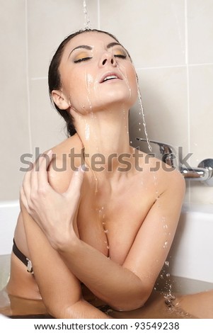 profile of beautiful girl taking shower - close-up portrait in the bath