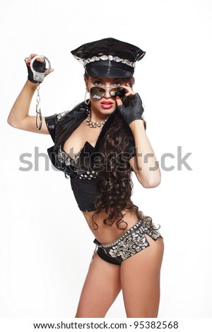sexy beautiful  brunette semi nude police woman with long curly hair with handcuffs with glasses with bright makeup and red lips isolated on white