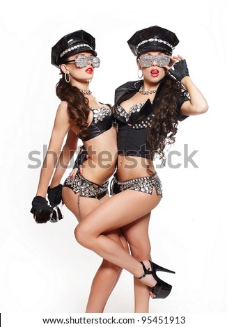 two sexy beautiful  brunette semi nude police women with long curly hair with handcuffs in fashion glasses with bright makeup and red lips isolated on white