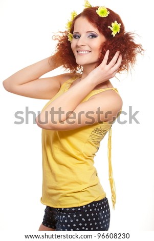 Portrait of beautiful smiling redhead ginger woman in yellow cloth with yellow flowers in hair isolated on white
