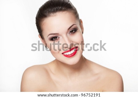 closeup portrait of sexy smiling caucasian young woman model with glamour red lips,bright makeup, eye arrow makeup, purity complexion. Perfect clean skin.white teeth