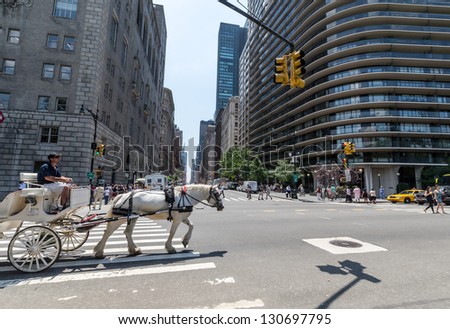 NEW YORK CITY - JULY 12: Horse-Drawn Carriage rides near Central Park on July 12, 2012 in New York. Central Park is a public park at the center of Manhattan in New York City. The park opened in 1857.