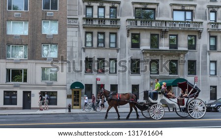 NEW YORK CITY - JULY 12: Horse-Drawn Carriage rides near Central Park on July 12, 2012 in New York. Central Park is a public park at the center of Manhattan in New York City. The park opened.