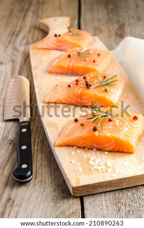 Raw salmon steaks on the wooden board