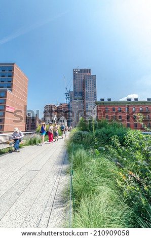 NEW YORK CITY - JULY 22: People walk along the High Line Park on July 22, 2014. The High Line is a popular linear park built on the elevated former New York Central Railroad spur in Manhattan.