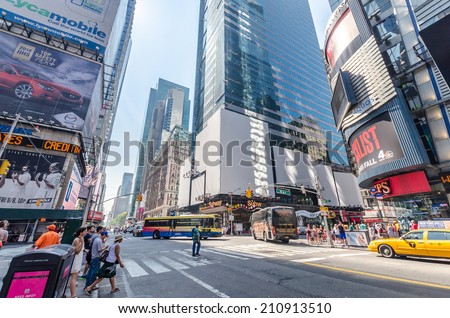 NEW YORK CITY - JULY 22: Undefined people pass through Times Square on July 22, 2014 in New York. Times Square is a major commercial intersection in Manhattan, at the junction of Broadway and 7th Ave.