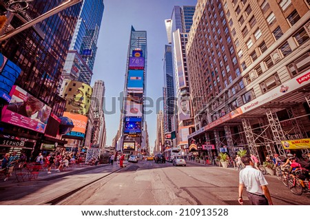 NEW YORK CITY - JULY 22: Undefined people pass through Times Square on July 22, 2014 in New York. Times Square is a major commercial intersection in Manhattan, at the junction of Broadway and 7th Ave.