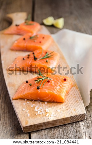 Raw salmon steaks on the wooden board
