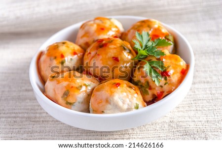 Chicken meatballs with parmesan under spicy sauce