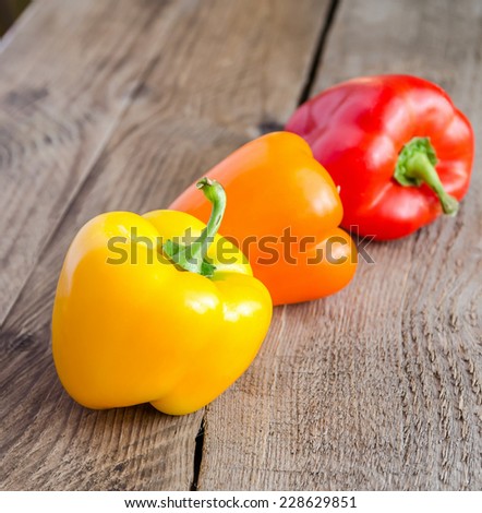 Bell peppers on the wooden background