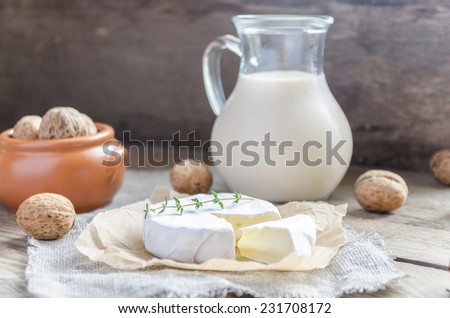 Camembert with pitcher of milk and whole nuts