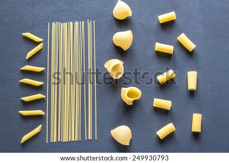 Various types of pasta on the dark background