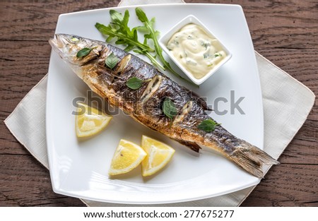 Grilled sea bass on the wooden board