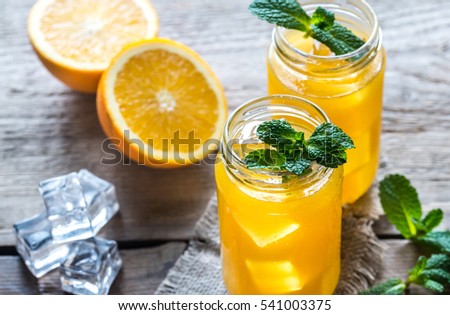Glass jars of orange juice