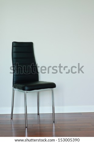 Black leather chair on blank wall