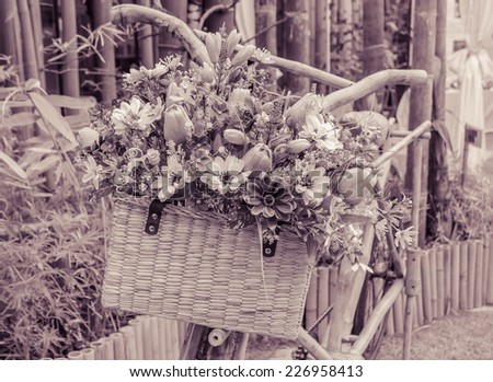 Wooden bicycle with a bucket of colorful flowers