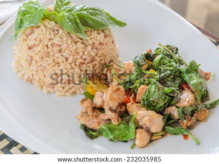 Fried chicken with sweet basil leave on brown rice, Thai cuisine
