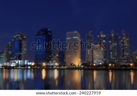 Bangkok city skyline at night with reflection on water - Blurred bokeh background