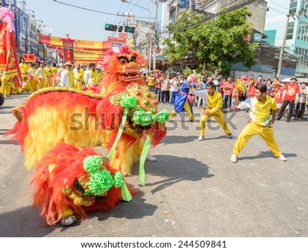 NAKHONSAWAN,THAILAND - FEBRUARY 13: Chinese New Year parade on February 13, 2013 in Nakhonsawan, Thailand. Chinese lion dance performance for Chinese New Year Celebrations.