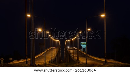 Surat Thani, Thailand - February 18, 2015: Night view of Si Surat bridge in Surat Thani, Thailand. Si Surat bridge is the crossing bridge of Tapi river.