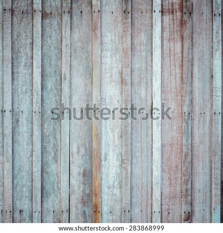Rough wooden wall with the hammered rusty nails background
