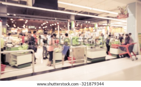 Supermarket store blur background ,Cashier counter with customer. Vintage filter effect image
