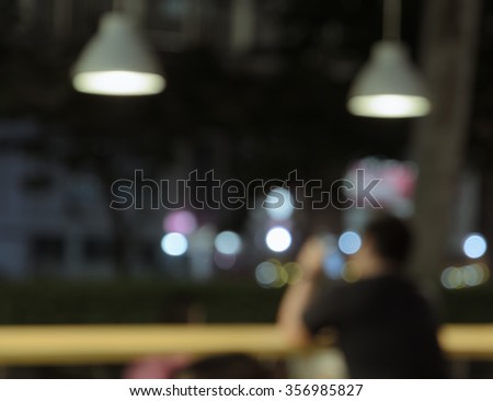Blur image outdoor coffee shop or bar with festival bokeh lights at night