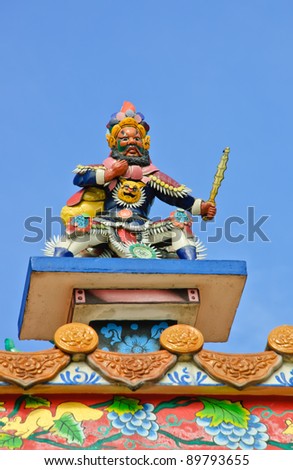 Chinese god sculpture on temple roof