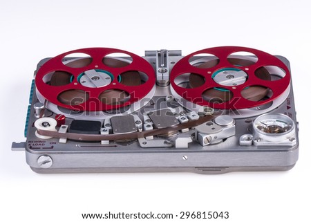 Wide shot of a reel to reel audio tape recorder on white background