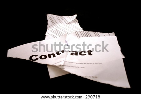 Torn up contract, isolated on black