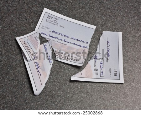 A mortgage payment check torn into pieces. The check is entirely original artwork and the routing number is deliberately too short.