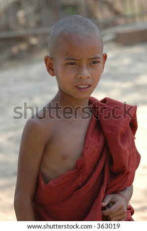 a very young boy Buddhist monk who was walking along a road in the countryside in Burma
