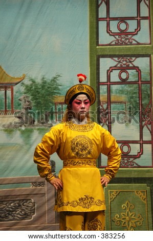 Chinese opera performer on stage in full makeup and costume