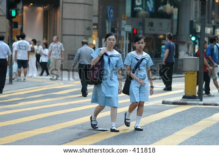 Hong Kong Stock-photo-two-schoolgirls-in-uniform-crossing-a-bust-intersection-in-central-district-downtown-hong-kong-411818