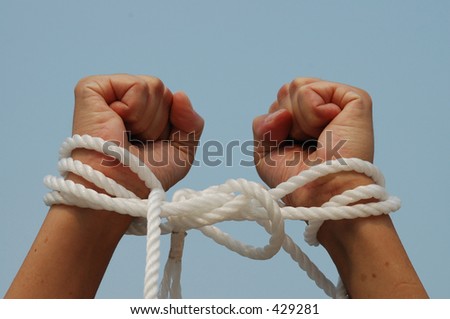 Pair of hands bound with rope