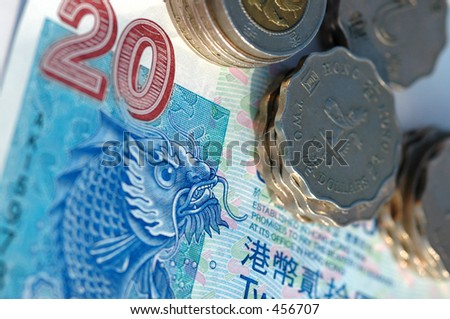 Macro of Hong Kong money, a twenty (20) dollar bill and a pile of coins