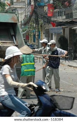 Rubbish or trash collectors on a street in Hanoi, Vietnam