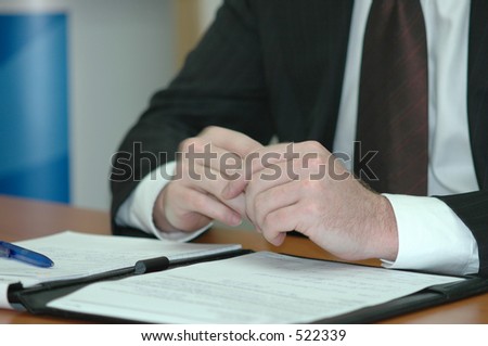 business man sitting at a board room table during a  meeting