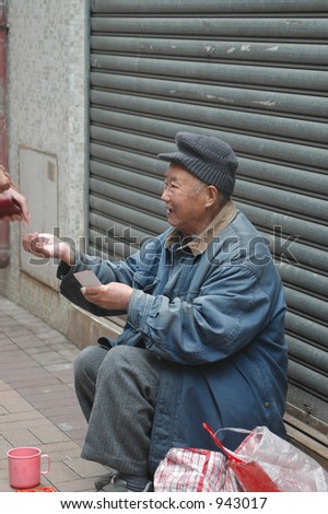 an old chinese man begging in an alley in Hong Kong
