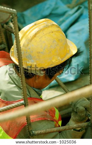 a construction worker about to enter a sewer tunnel along the road with safety wear