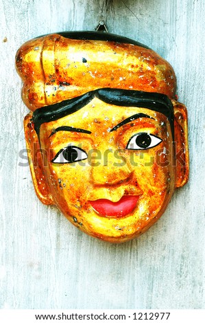 Vietnamese water puppet mask against a washed out wall