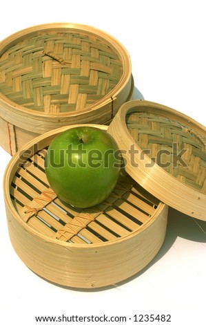 Healthy eating Chinese style with a green apple in a steam dim sum basket
