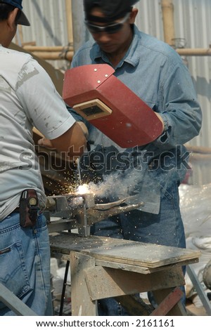 Electrical workers and welders at a construction site