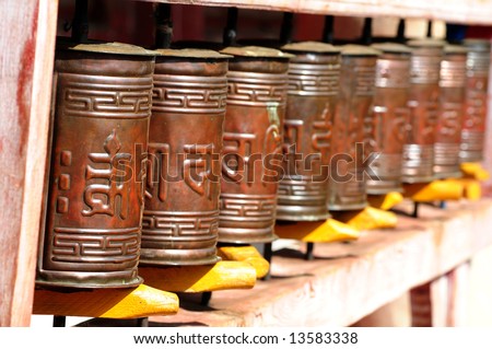 A set of Tibetan Buddhist prayer wheels at a temple in Mongolia – selective focus on first wheel