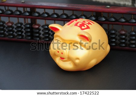 Chinese Coin or piggy bank with Chinese abacus in the background