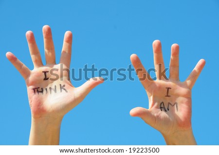 Hands with the words I think, I am written on them