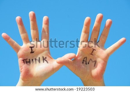 Hands with the words I think, I am written on them