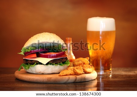 Close up of big tasty burger french fries and beer Close up of big tasty burger french fries and beer