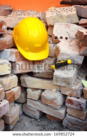 Bricks, trowel and helmet on work place